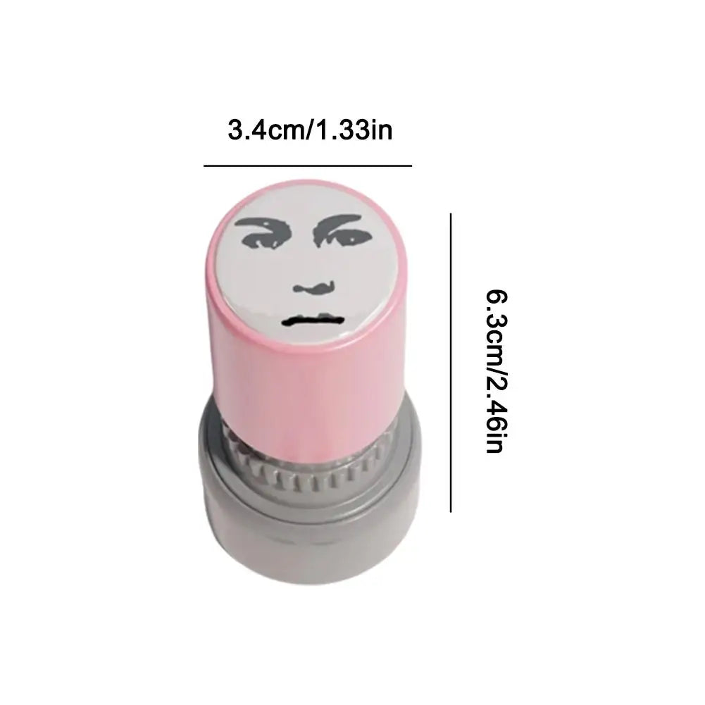 A pink rubber stamp with a black meme face design, measuring 3.4cm wide and 6.3cm tall.