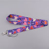 A purple floral heart-shaped lanyard featuring pink, orange, and white patterns for badges and keys.