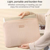 A person holds a light pink laptop sleeve designed for carrying notebooks or laptops.