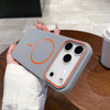 A hand holds a gray magnetic wireless charging phone case with a circular orange indicator light on the back.