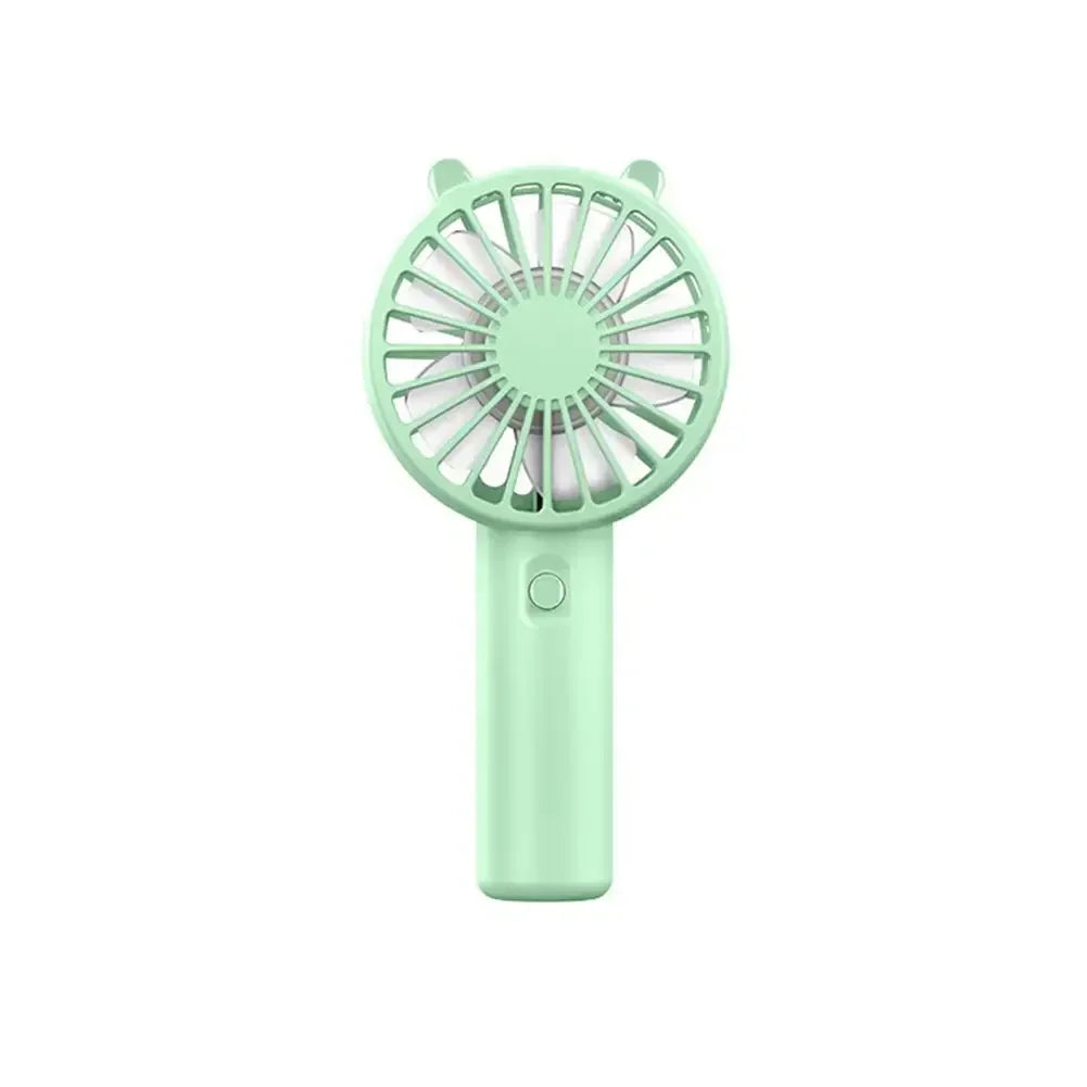 A mint green mini handheld fan with a circular grille and a long body.