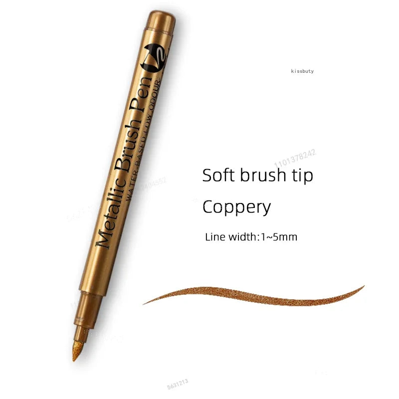 A close-up of a metallic brush pen with a soft tip, showing the gold color and line width.