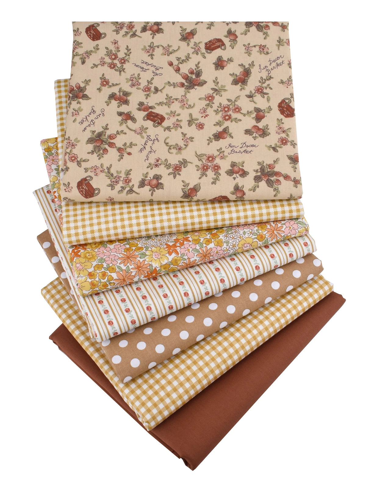 Gestapelte Twill-Baumwollstoffe mit Blumen- und Karomustern in Beige-, Gelb- und Brauntönen.