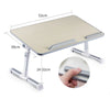 A portable adjustable laptop desk stand with a light wood-colored surface and silver metal frame.