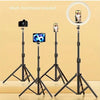A set of three black multifunctional tripods are displayed, holding a camera, a smartphone, and a ring light.