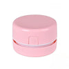 Pinker Mini-Schreibtischstaubsauger mit runder Abdeckung und Knopf.