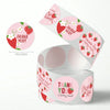 Roll of pink and red adhesive stickers with thank you messages and strawberries