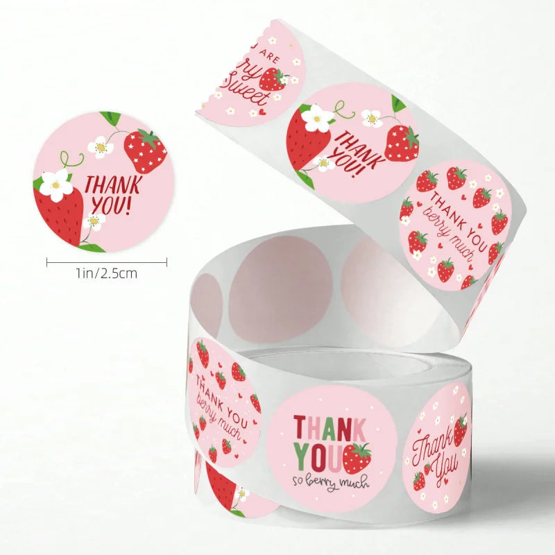 Roll of pink and red adhesive stickers with thank you messages and strawberries