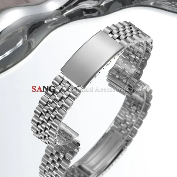 A close-up view of a polished stainless steel watch band with a folding clasp.