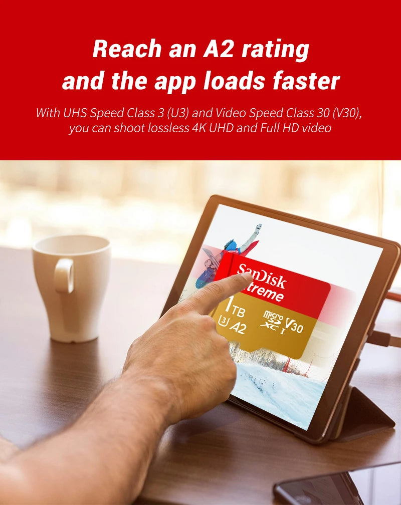 A hand touches a tablet screen displaying a video loading interface with text about reaching an A2 rating and faster loading 