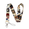 A patterned cat-themed lanyard featuring various cats and stars, attached to a metal clip.