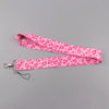 Pink heart-shaped lanyard with a pink background for badges and keys