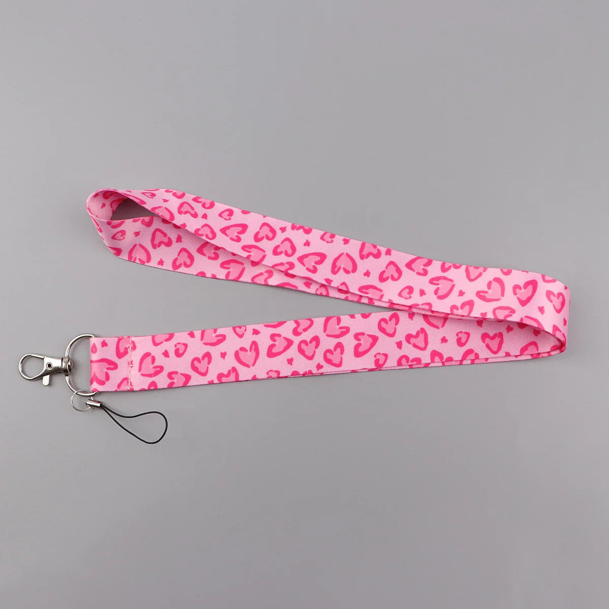 Pink heart-shaped lanyard with a pink background for badges and keys