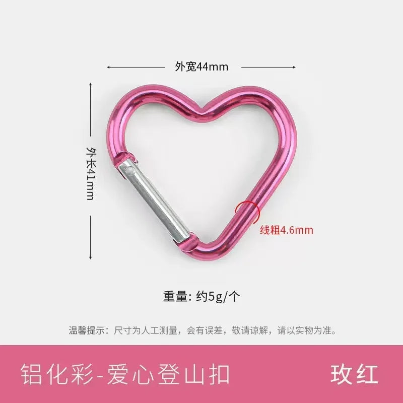 A pink heart-shaped spring clasp and carabiner keychain, with dimensions noted.