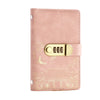A pink leather personal finance budget binder with a gold-toned lock and embossed design.