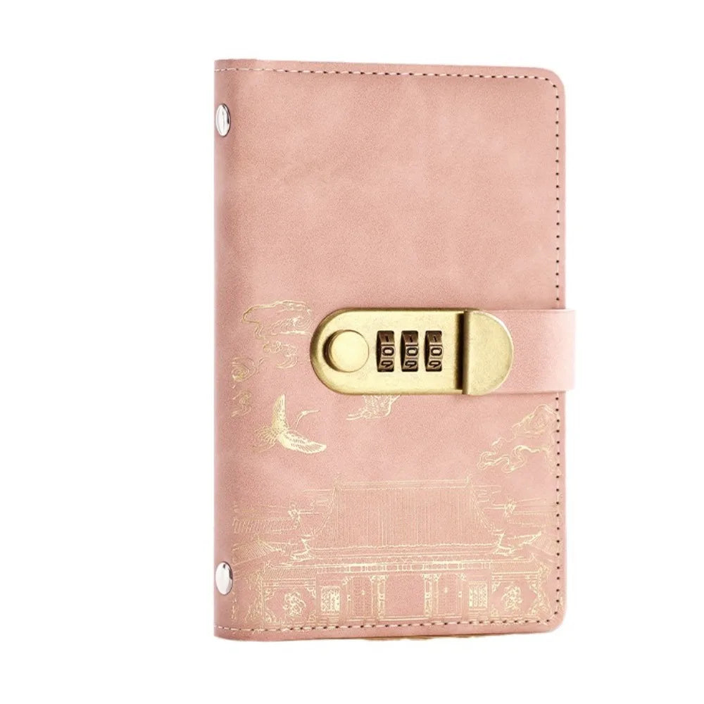 A pink leather personal finance budget binder with a gold-toned lock and embossed design.