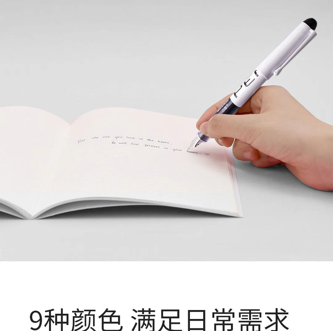 A hand is writing in a notebook with a white fine point fountain pen on a gray surface.
