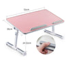 A pink portable adjustable laptop desk stand with a 52cm surface and adjustable arms.