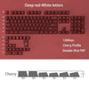 A close-up view of dark red and white PBT keycaps with a cherry profile for mechanical keyboards.