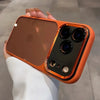 An orange clear shockproof case with camera lens protection for an iPhone is held in a hand.