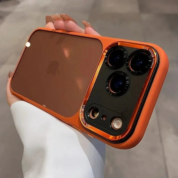 An orange clear shockproof case with camera lens protection for an iPhone is held in a hand.