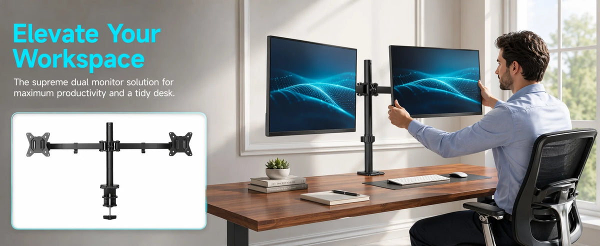 A man is using a heavy duty dual monitor desk mount to position two computer monitors on a wooden desk.