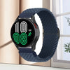 A black smartwatch with a dark blue knitted nylon strap displaying a digital timer on a light background.