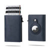 A dark blue slim leather wallet with a card pop-up feature shown next to a stack of similar wallets.