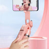 A hand holds a pink 360° rotation selfie stick with a smartphone attached, capturing a beautiful moment.