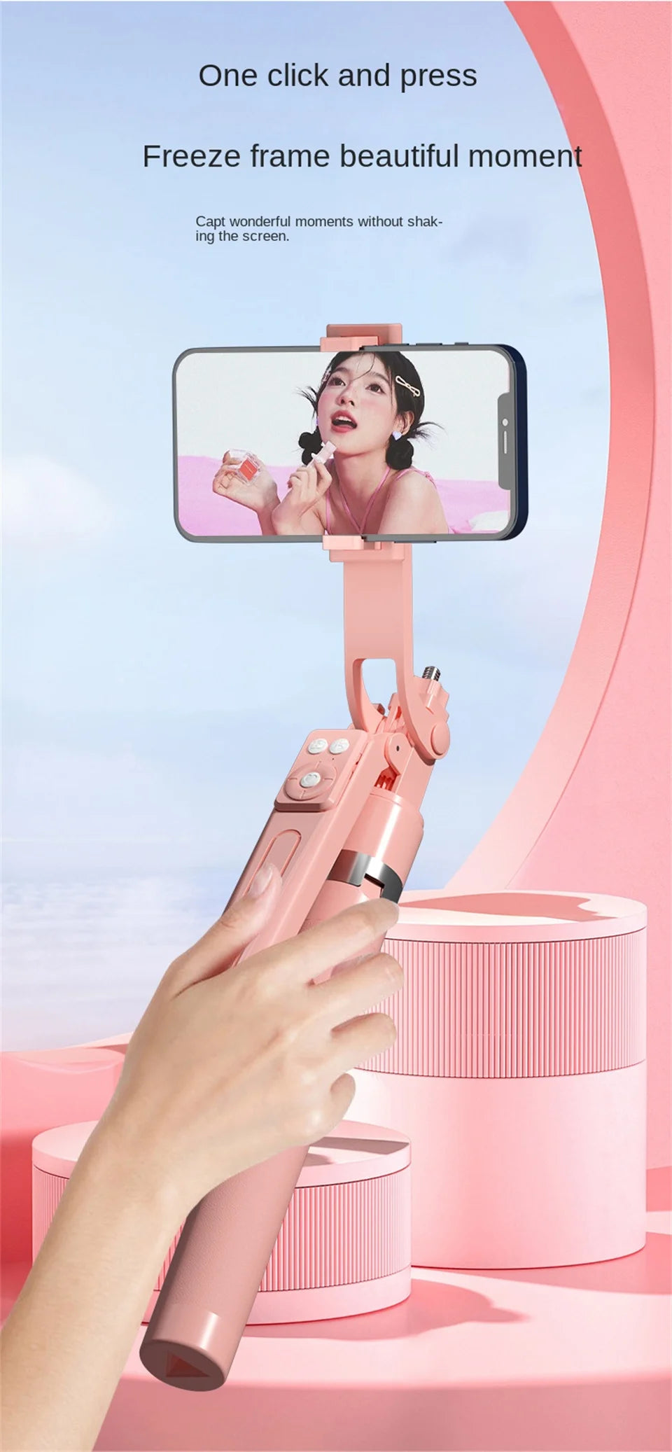 A hand holds a pink 360° rotation selfie stick with a smartphone attached, capturing a beautiful moment.