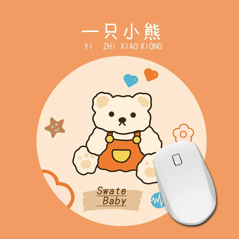 A cute bear-themed mouse pad featuring a sweet baby design and a white computer mouse.