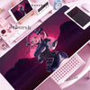 A pink-haired anime character illustration on a purple desk mat next to a tablet and mouse.