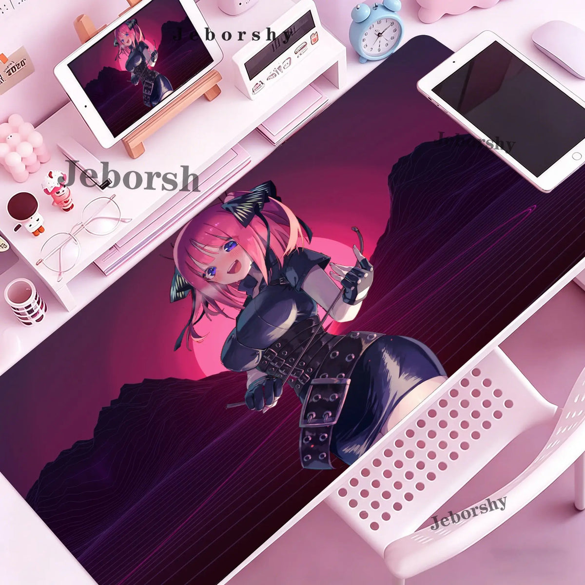 A pink-haired anime character illustration on a purple desk mat next to a tablet and mouse.