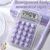 A clear plastic portable mini calculator with a purple body and a digital display is shown on a white surface.