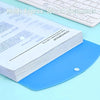 A stack of white A4 plastic expanding file envelopes with blue snap buttons on a light blue surface.