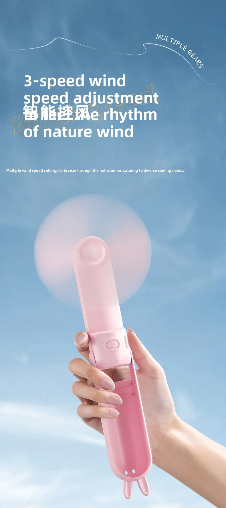 A hand holds a pink portable foldable rabbit mini fan against a light blue sky.