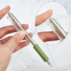 A hand holds a precision utility knife set with green and clear blades against a white background.