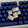 A close-up view of dark blue PBT keycaps with cherry profile for mechanical keyboards