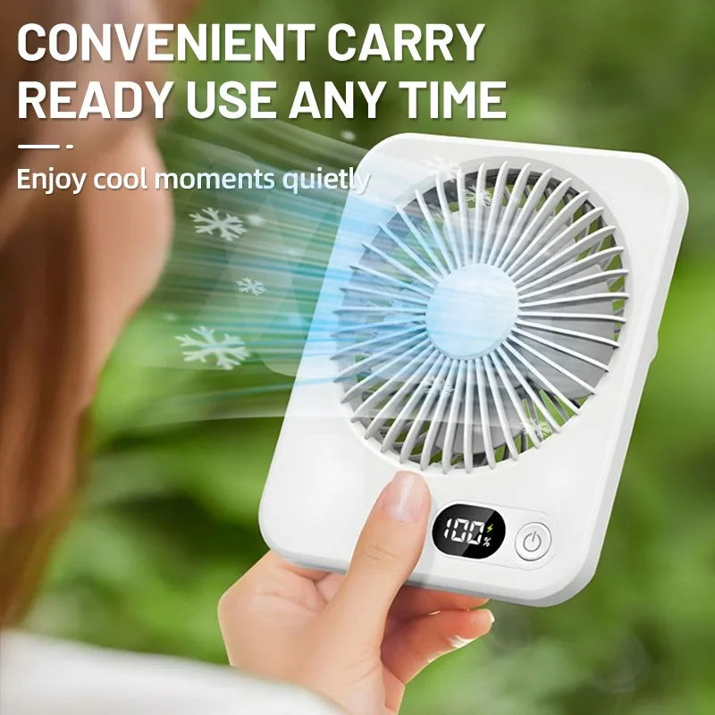 A hand holds a white portable fan, demonstrating its convenient carry and ready-to-use feature.