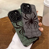 A dark green phone case featuring a black spider web design, held by a hand.