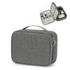 A gray travel cable organizer bag with a zippered compartment and an open lid showing various electronic cables and accessori