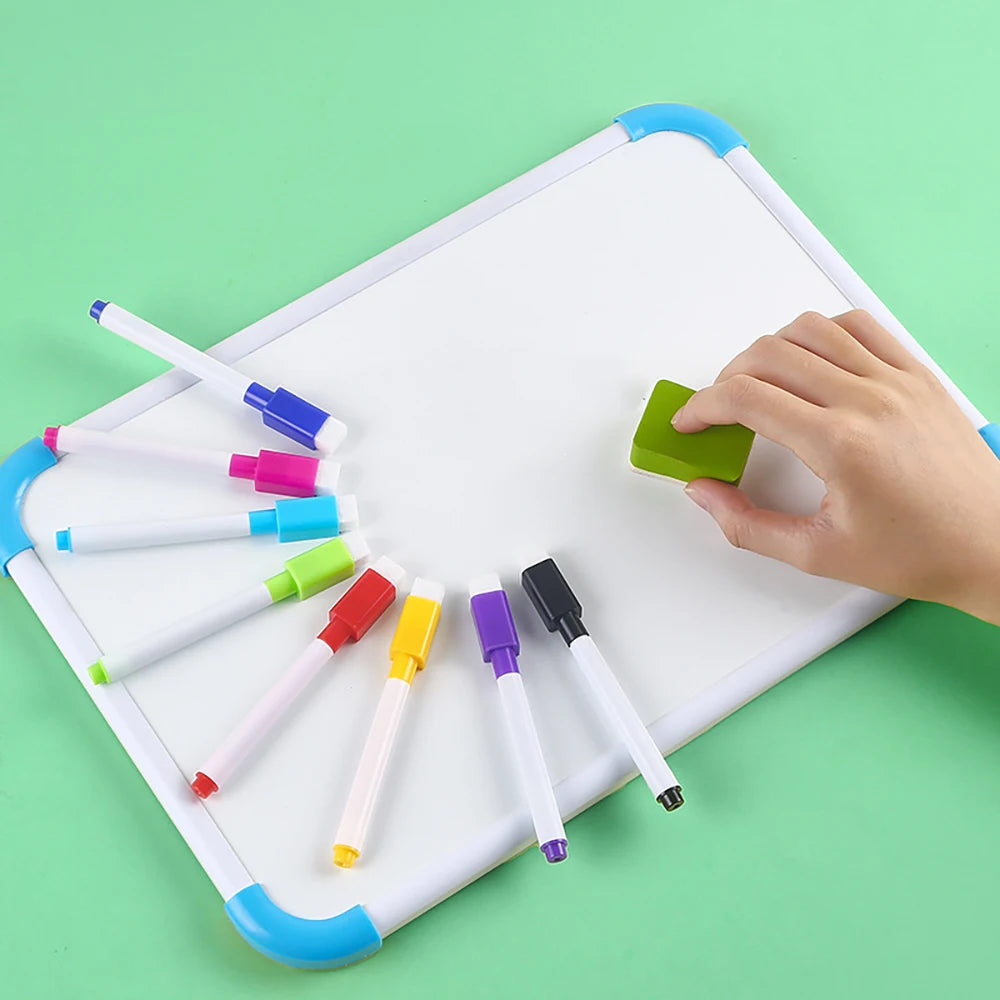 An overhead view of an 8-pack of magnetic whiteboard pens in various colors being held by a hand on a white board.