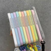 A set of magnetic candy contrast phone cases in pastel colors with a lanyard attached.
