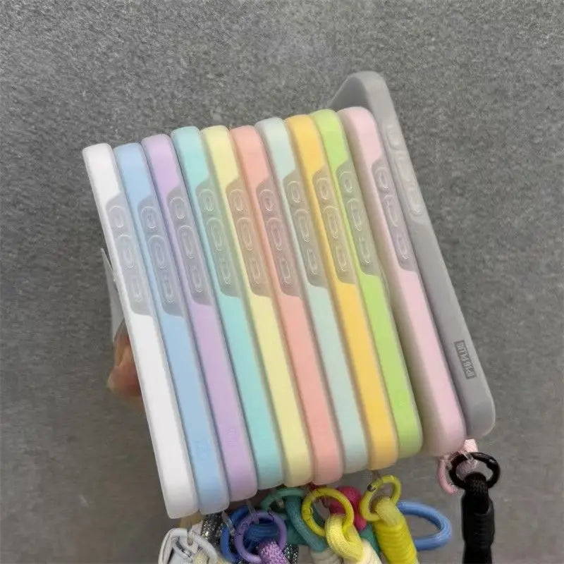 A set of magnetic candy contrast phone cases in pastel colors with a lanyard attached.