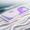 Low profile wired gaming keyboard with a numeric keypad shown from above on a wavy surface.