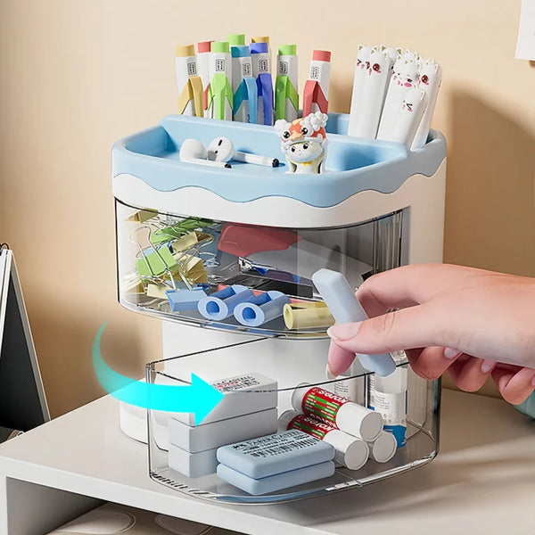 A clear acrylic desktop pen holder with multiple compartments filled with various colored pens and pencils.