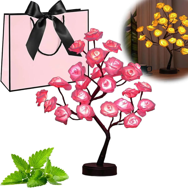 Pink rose tree LED night light with pink blossoms and green leaves displayed next to a pink gift bag.