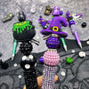 A set of Halloween DIY bead pens featuring witch charms and purple and black beads.