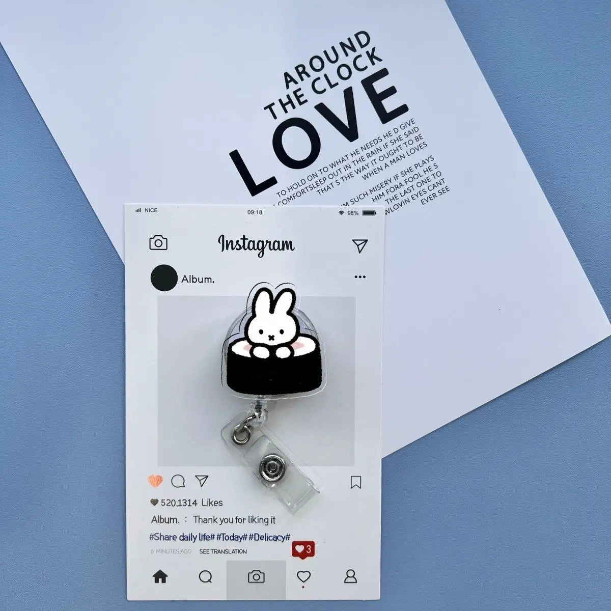 A silver badge reel with a cute Miffy rabbit charm is displayed on a white Instagram post.