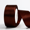 A roll of dark brown satin ribbon used for gift wrapping and DIY crafts.